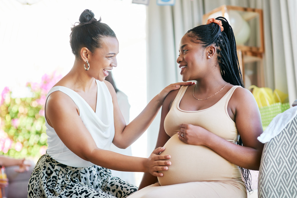 Friend supporting pregnant woman
